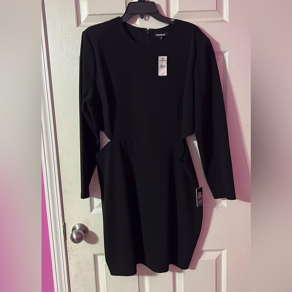 Brand new Sexy little black dress with small cut outs on each side near hip